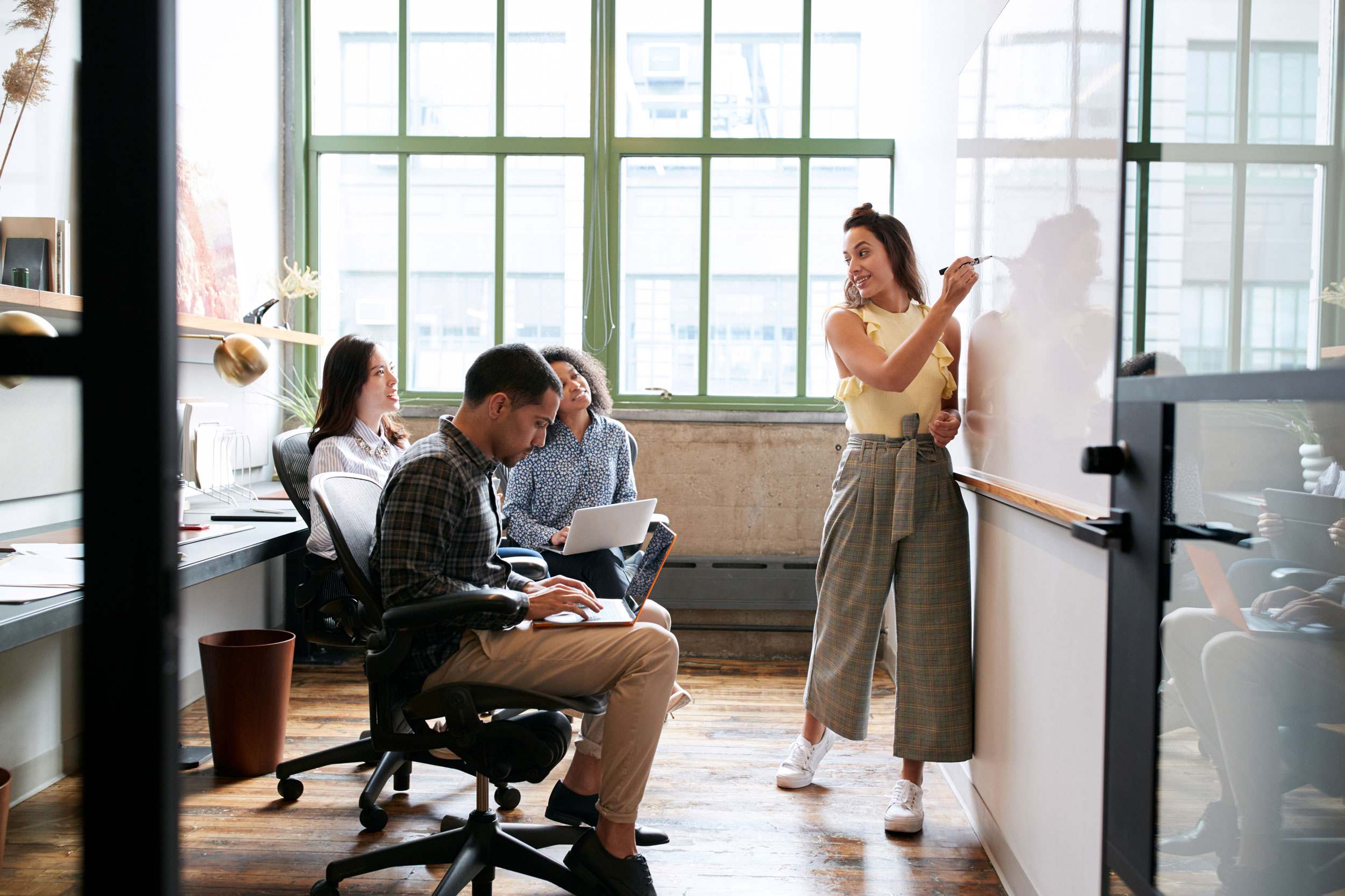 woman-writing-on-whiteboard-in-office
